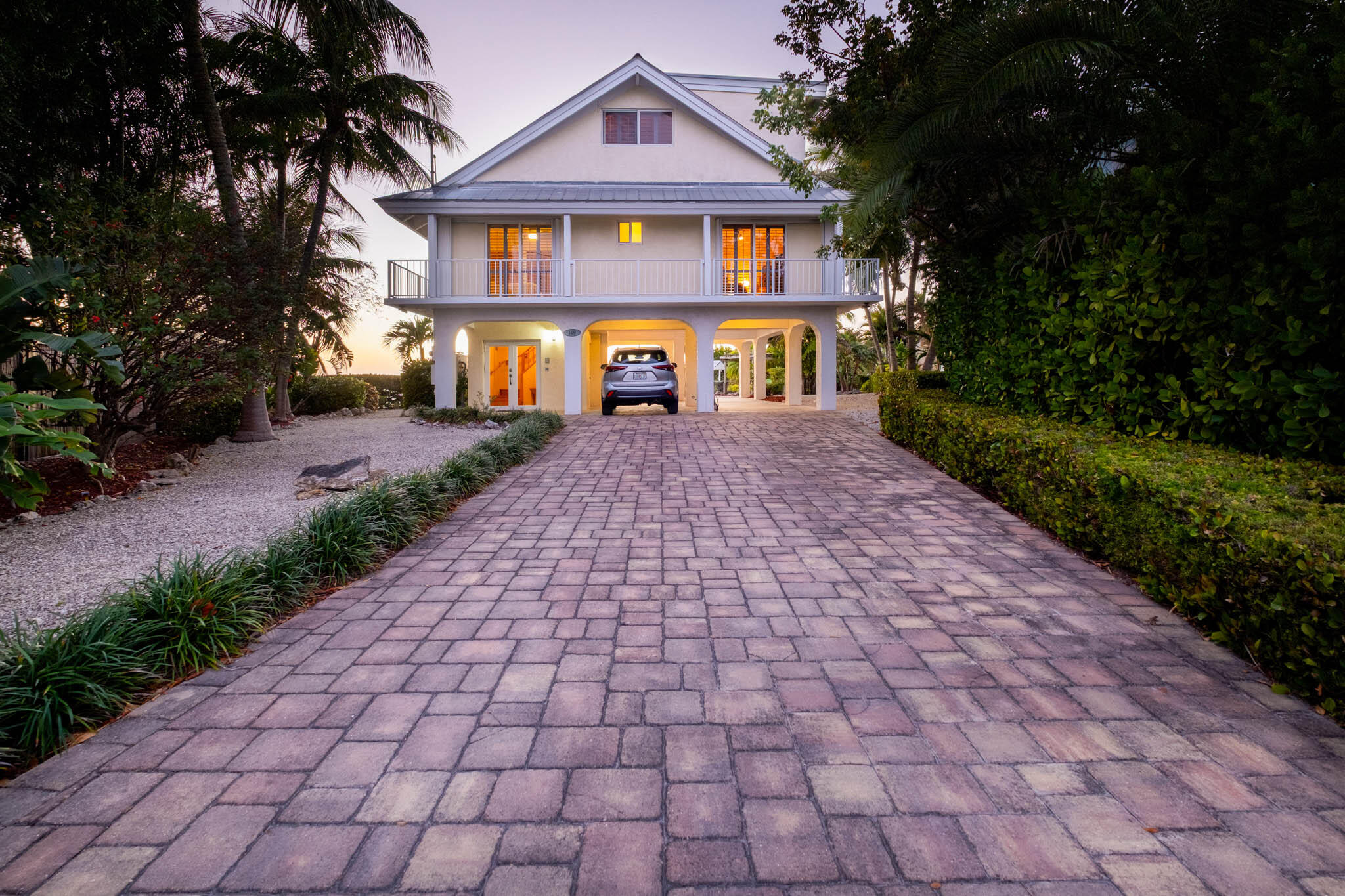 149 Lake Road Tavernier, FL 33070 - Photo 56 of 59 a front view of a house with yard and trees