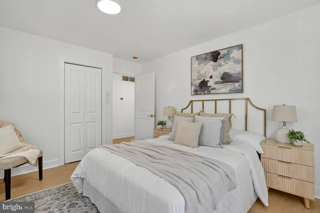 a bedroom with a bed and a painting on the wall