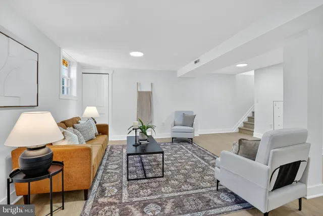a living room with furniture and a rug