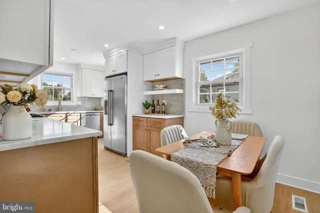 a living room with stainless steel appliances kitchen island granite countertop furniture and a view of kitchen