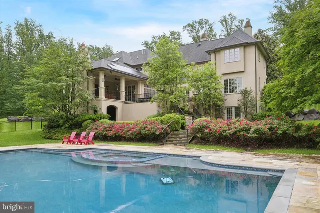 a front view of a house with a yard and potted plants