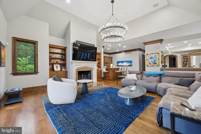 a living room with furniture a rug and a fireplace