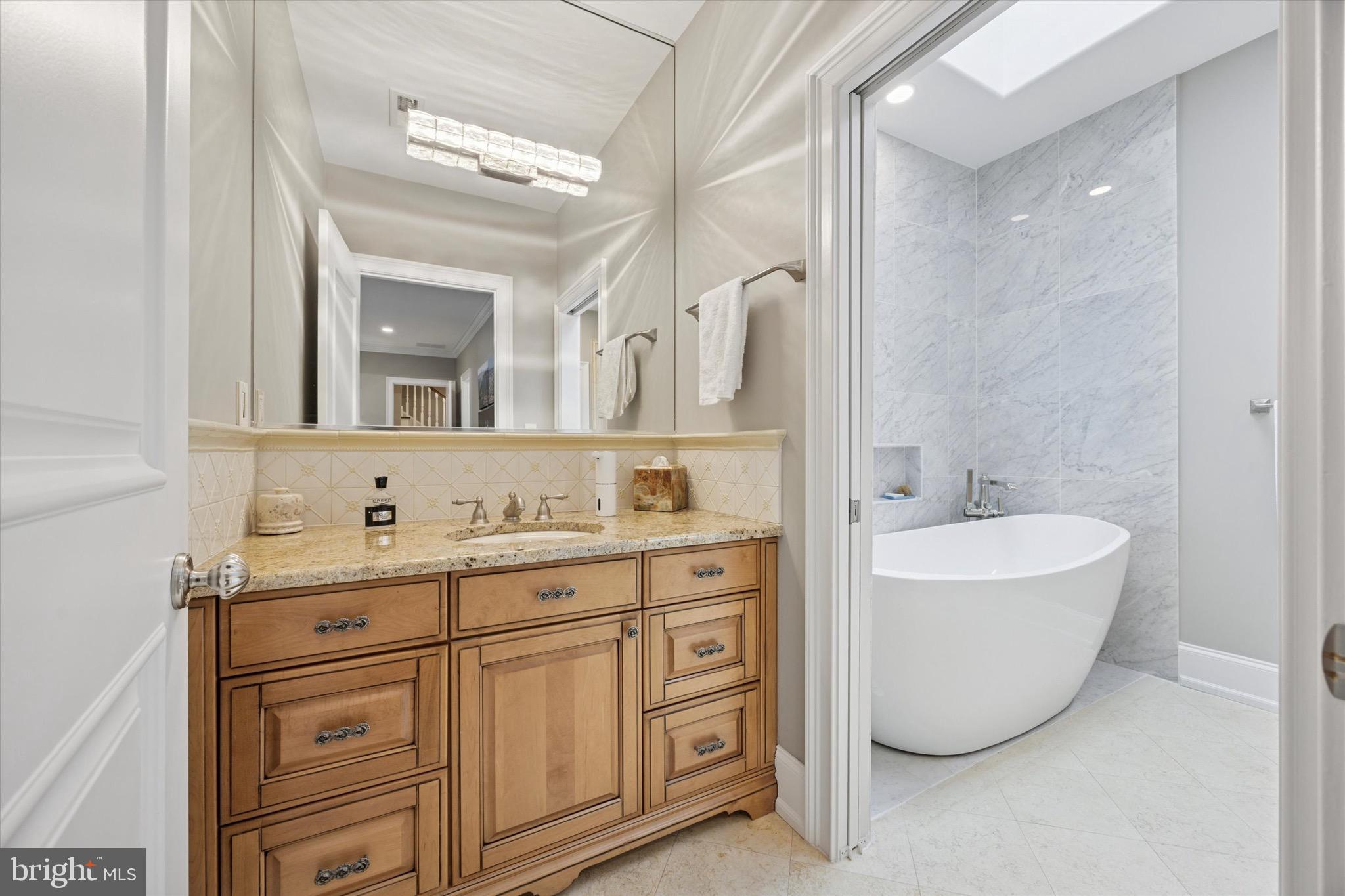631 Harts Ridge Road Conshohocken, PA 19428 - Photo 33 of 62 a bathroom with a tub sink double vanity and mirror