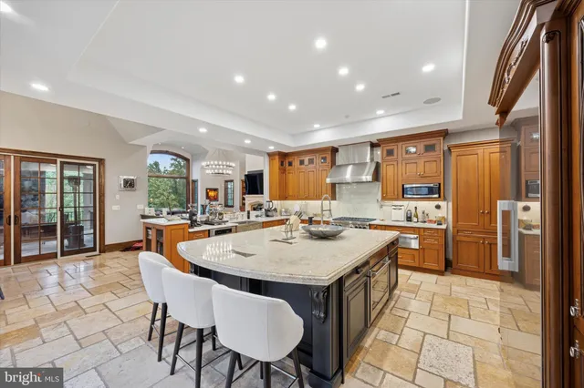 a kitchen with stainless steel appliances granite countertop a sink and stove