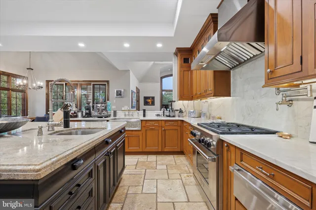 a kitchen with granite countertop wooden cabinets and a sink