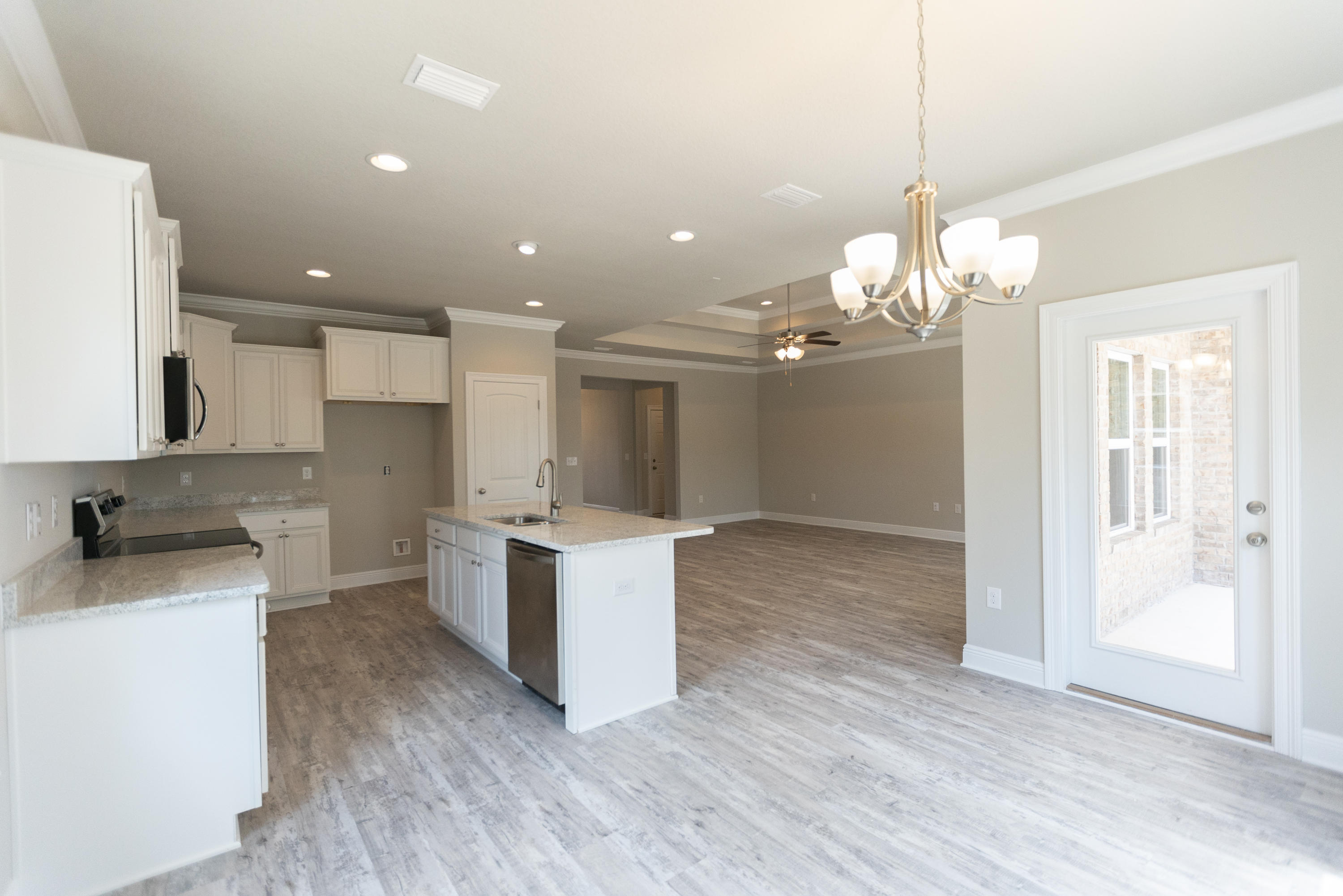 359 Wayne Trail Santa Rosa Beach, FL 32459 - Photo 5 of 39 a open kitchen with a sink a refrigerator and a stove top oven