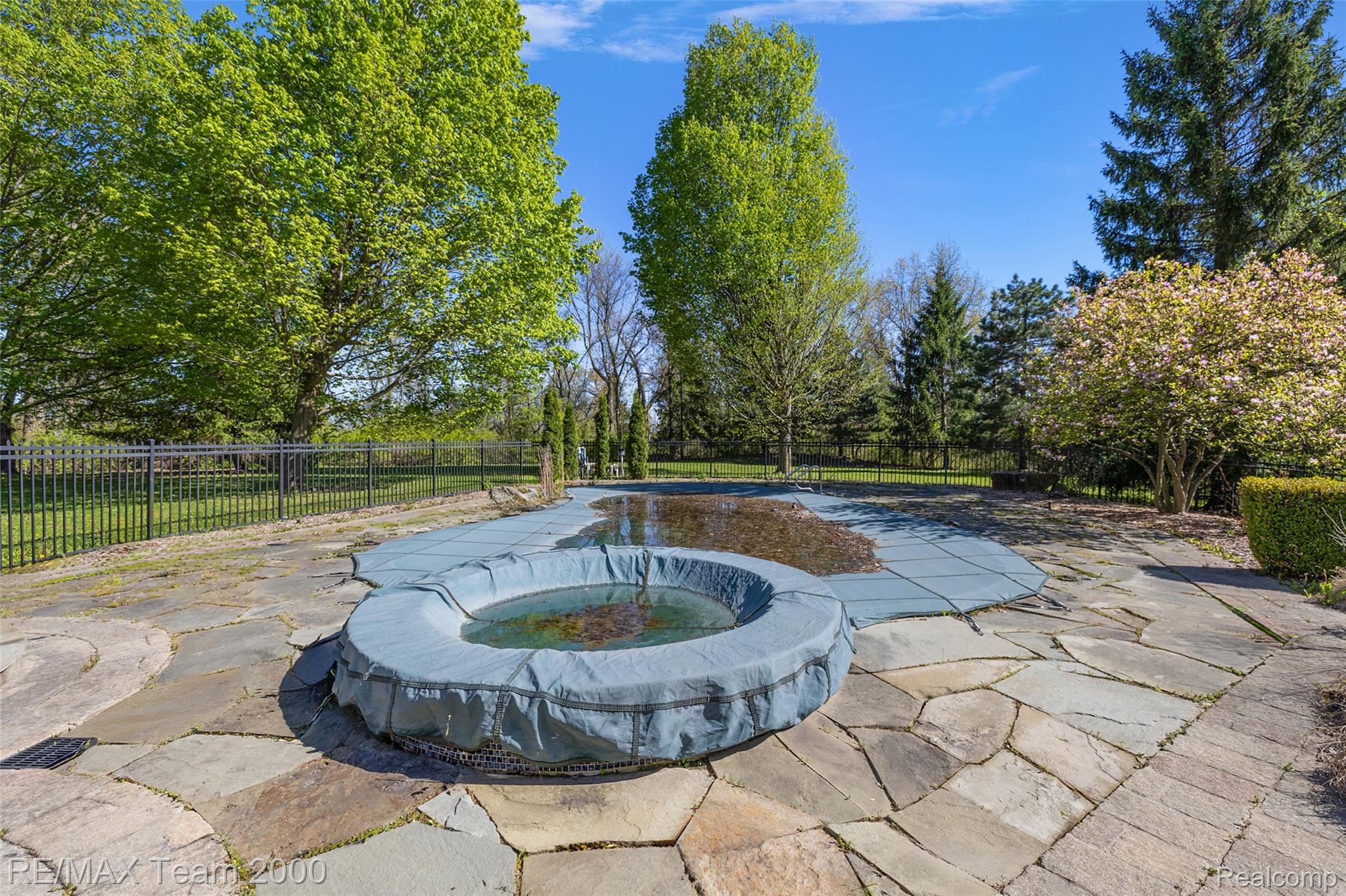 630 Sheldon Court Rochester, MI 48306 - Photo 7 of 94 View of swimming pool with a fenced backyard, patio surround, and an in-ground hot tub