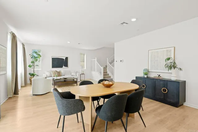 a view of a dining room with a table and chairs