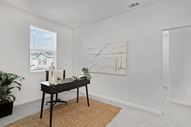 a view of a workspace with furniture