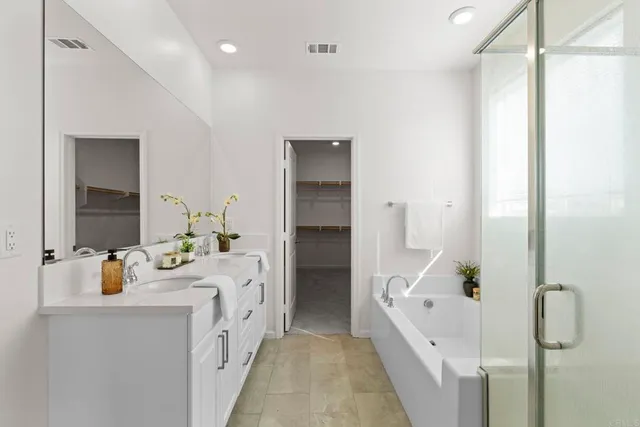 a bathroom with a double vanity sink a mirror and shower