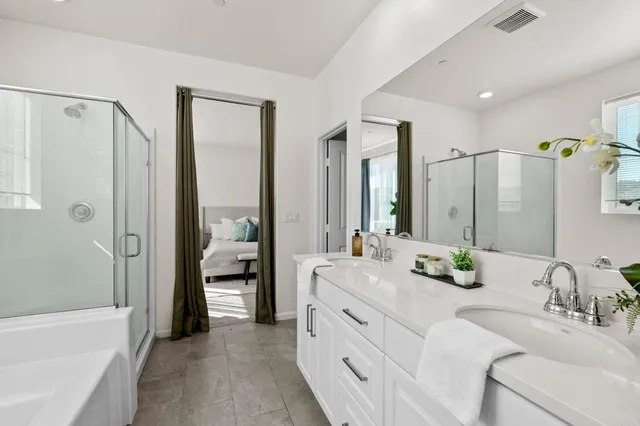 a bathroom with a double vanity sink mirror double and shower