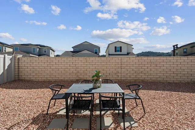 a view of a patio with a table and chairs