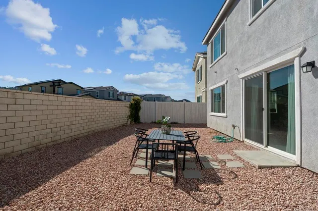 a view of a patio with a table and chairs