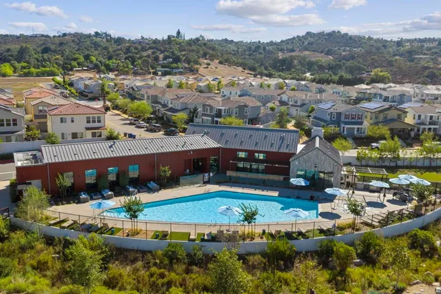 an aerial view of house with yard swimming pool and mountain view