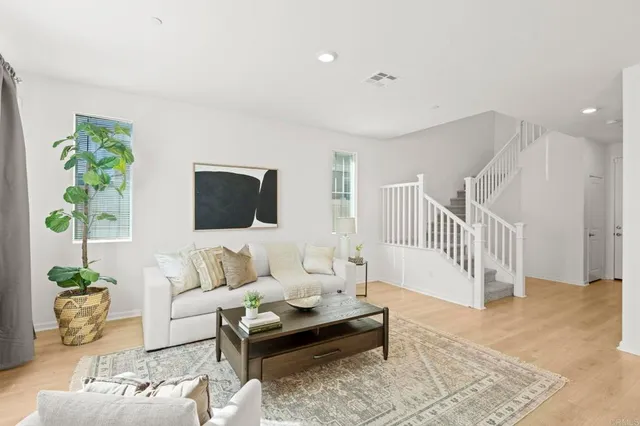 a living room with furniture and a potted plant