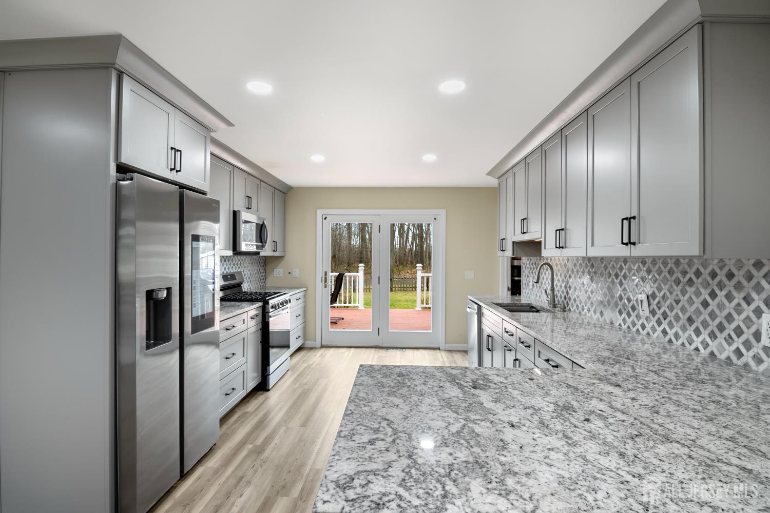 238 Princeton Hightstown Road Cranbury, NJ 08512 - Photo 12 of 51 a large white kitchen with stainless steel appliances granite countertop a refrigerator and a stove top oven