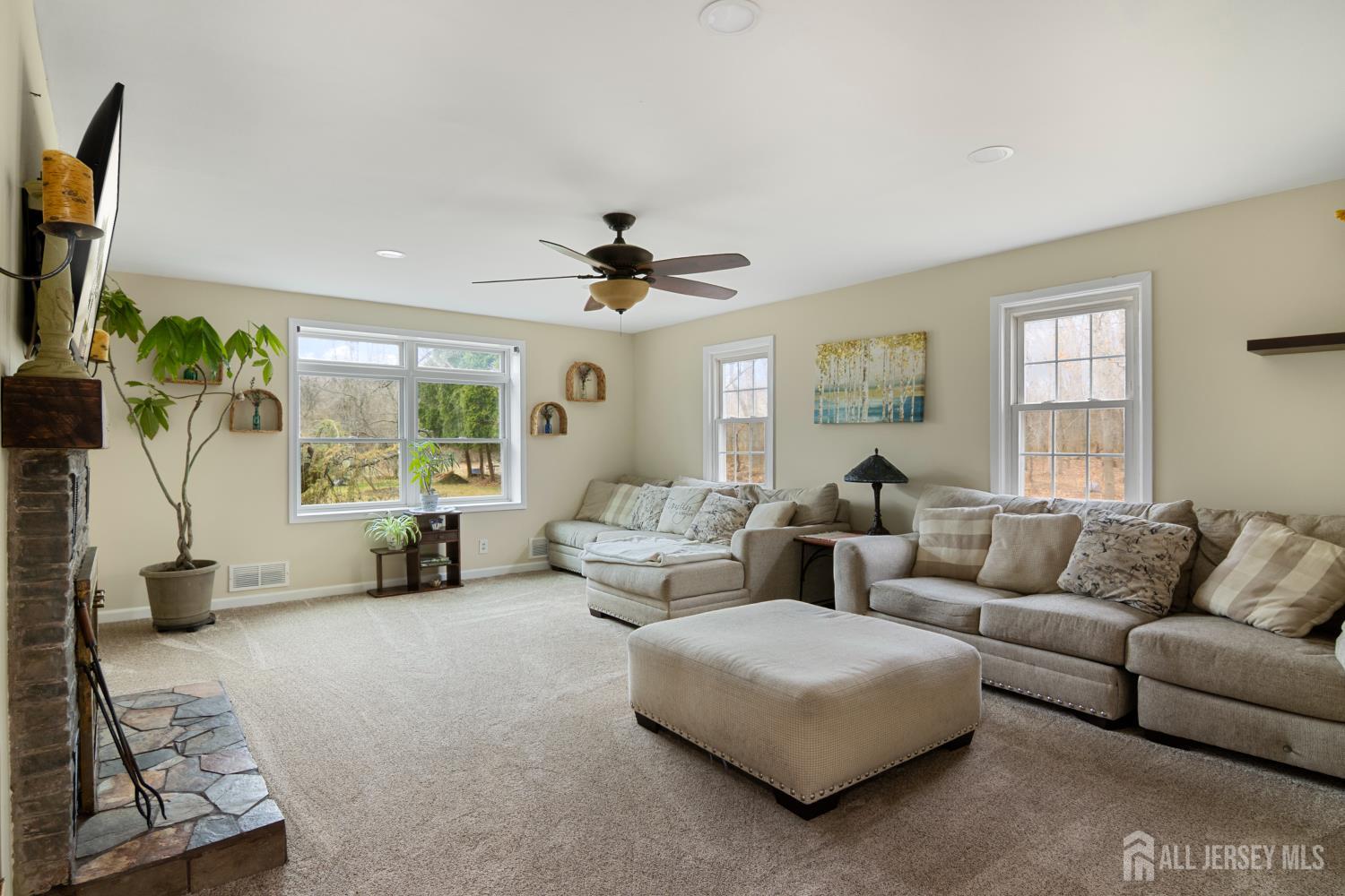238 Princeton Hightstown Road Cranbury, NJ 08512 - Photo 13 of 51 a living room with furniture and a flat screen tv