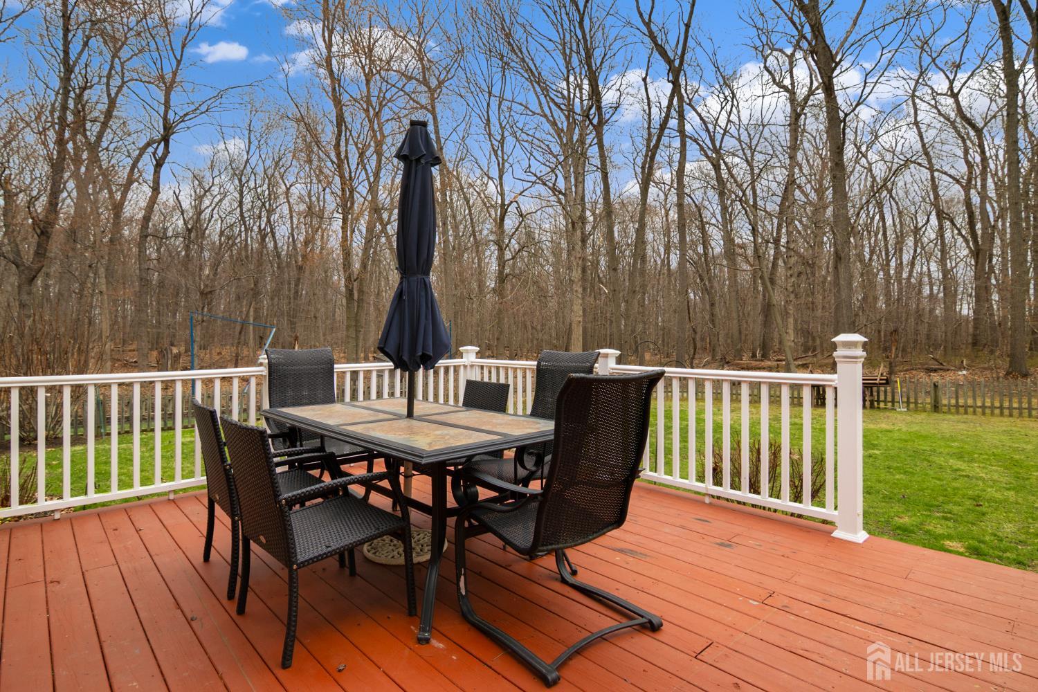 238 Princeton Hightstown Road Cranbury, NJ 08512 - Photo 35 of 51 a view of a deck with furniture and trees around