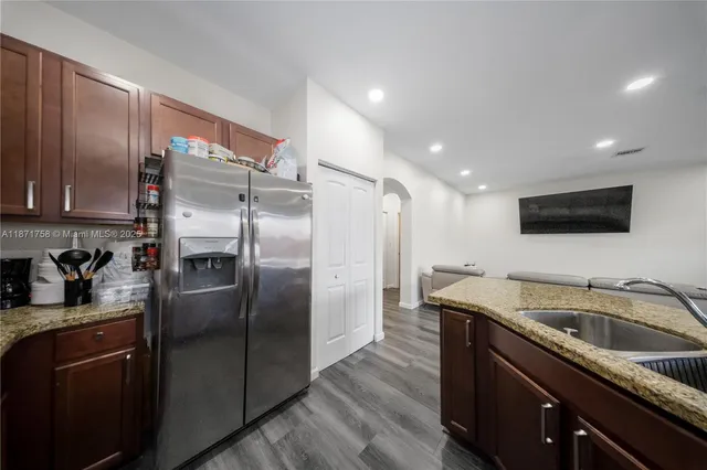 a kitchen with a refrigerator sink and microwave