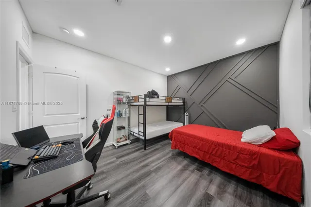 a bedroom with a bed and a chair