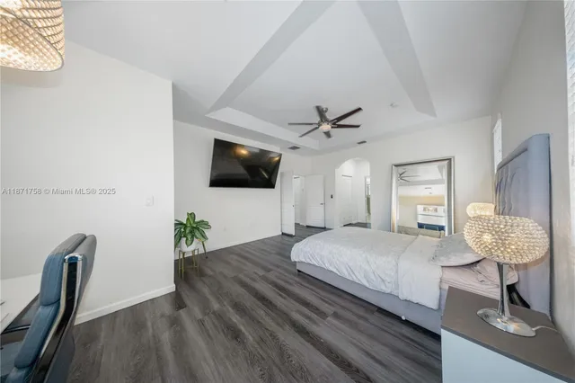 a bedroom with a bed window and a flat screen tv