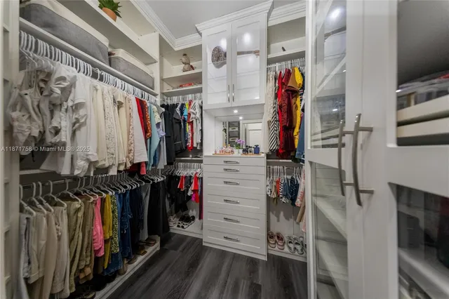 a view of walk in closet with clothes
