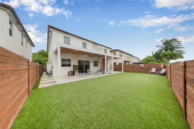 a view of a house with backyard and porch