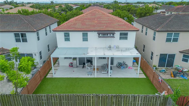 a view of a house with a yard patio and sitting area