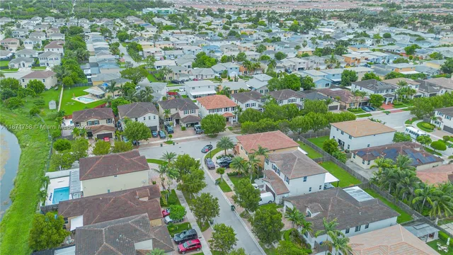 an aerial view of residential houses with outdoor space and street view