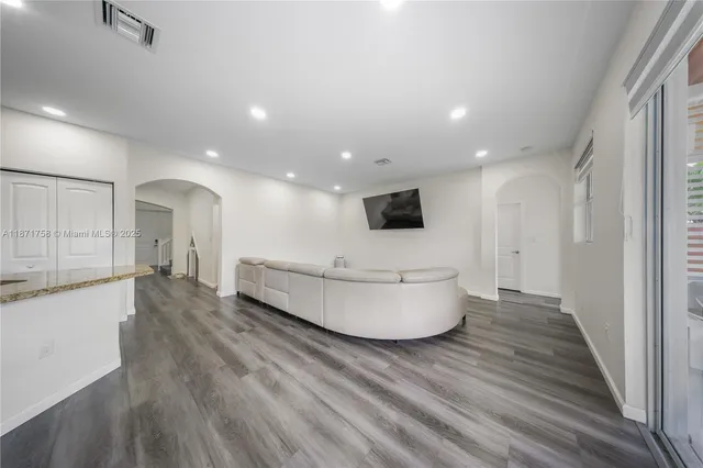 a large room with a lot of counter space and a wooden floor