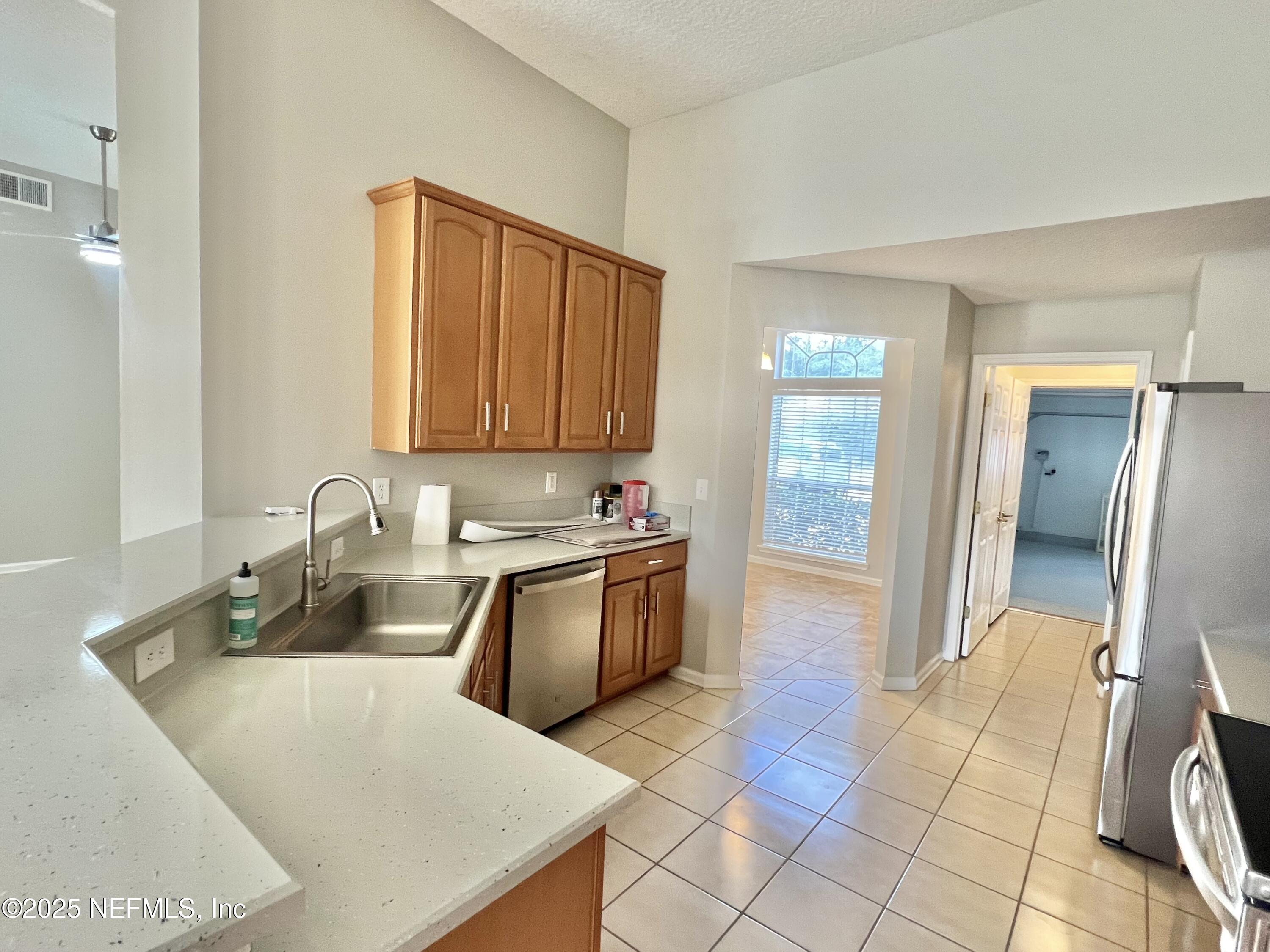 389 Sparrow Branch Circle St. Johns, FL 32259 - Photo 12 of 46 a large kitchen with granite countertop a sink and a stove top oven
