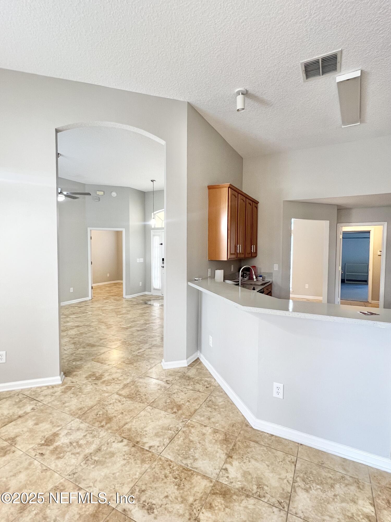 389 Sparrow Branch Circle St. Johns, FL 32259 - Photo 14 of 46 a view of a kitchen with a sink and a refrigerator