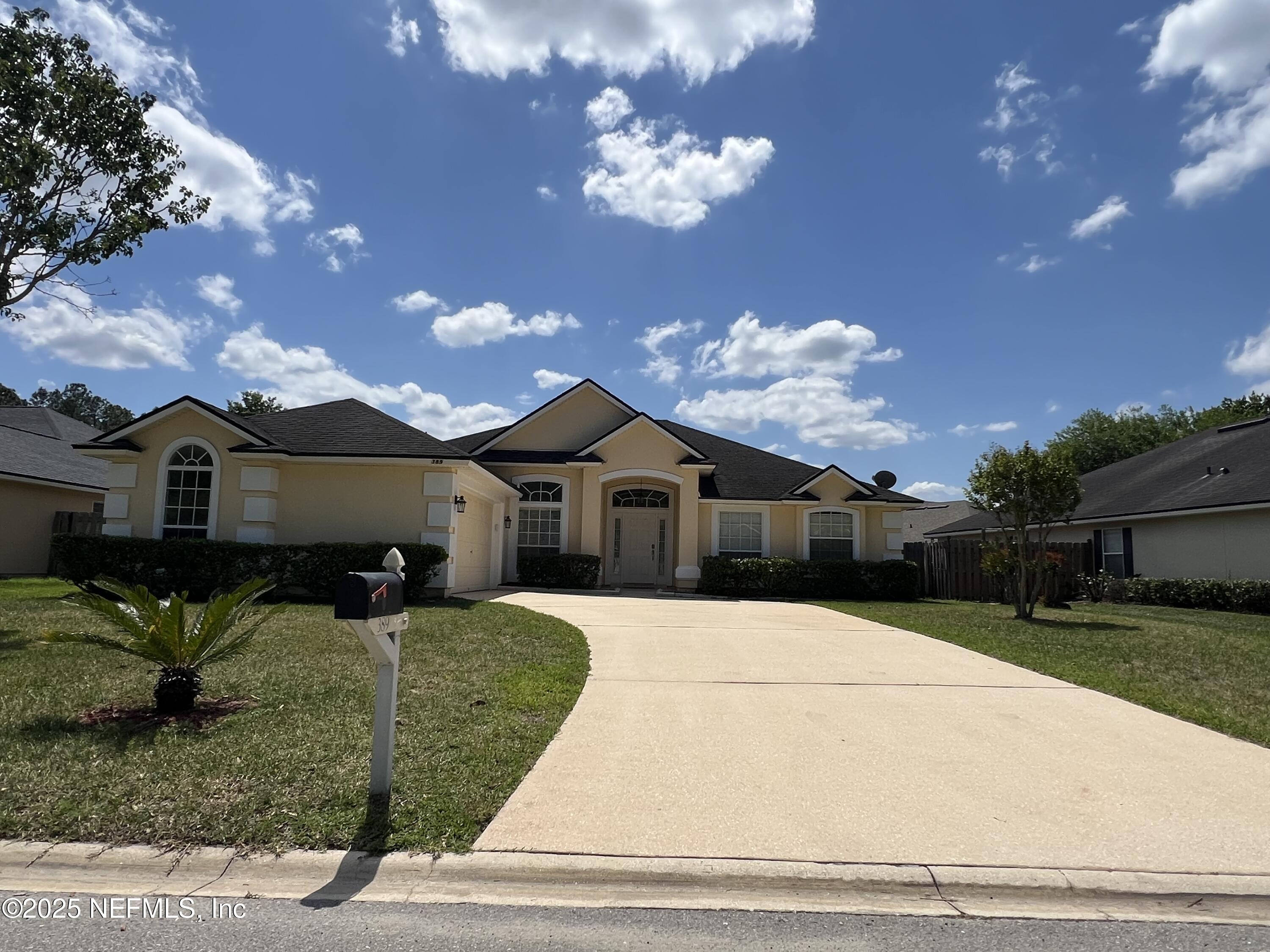 389 Sparrow Branch Circle St. Johns, FL 32259 - Photo 45 of 46 a front view of a house with a yard
