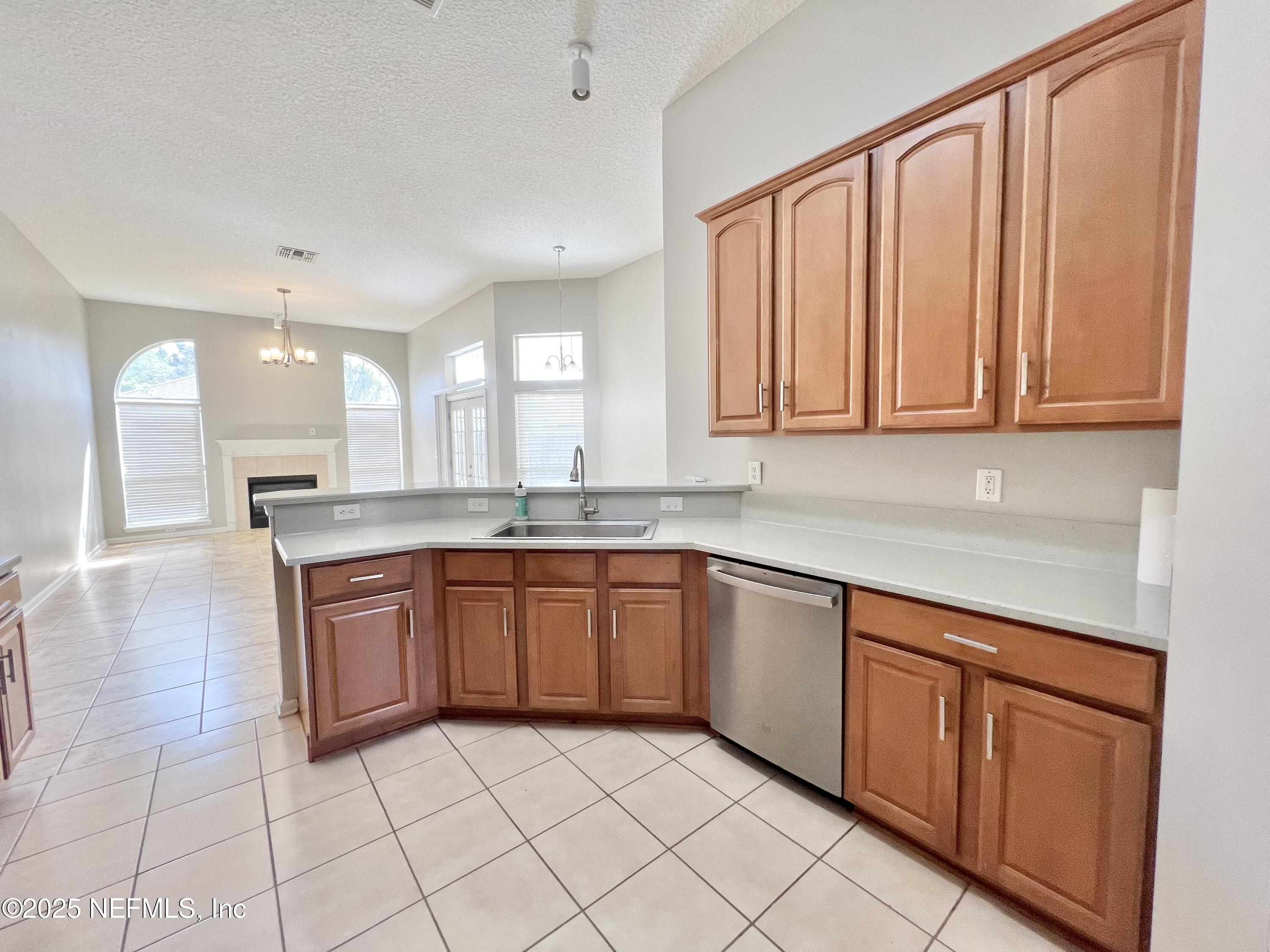 389 Sparrow Branch Circle St. Johns, FL 32259 - Photo 7 of 46 a large kitchen with stainless steel appliances granite countertop a sink and cabinets
