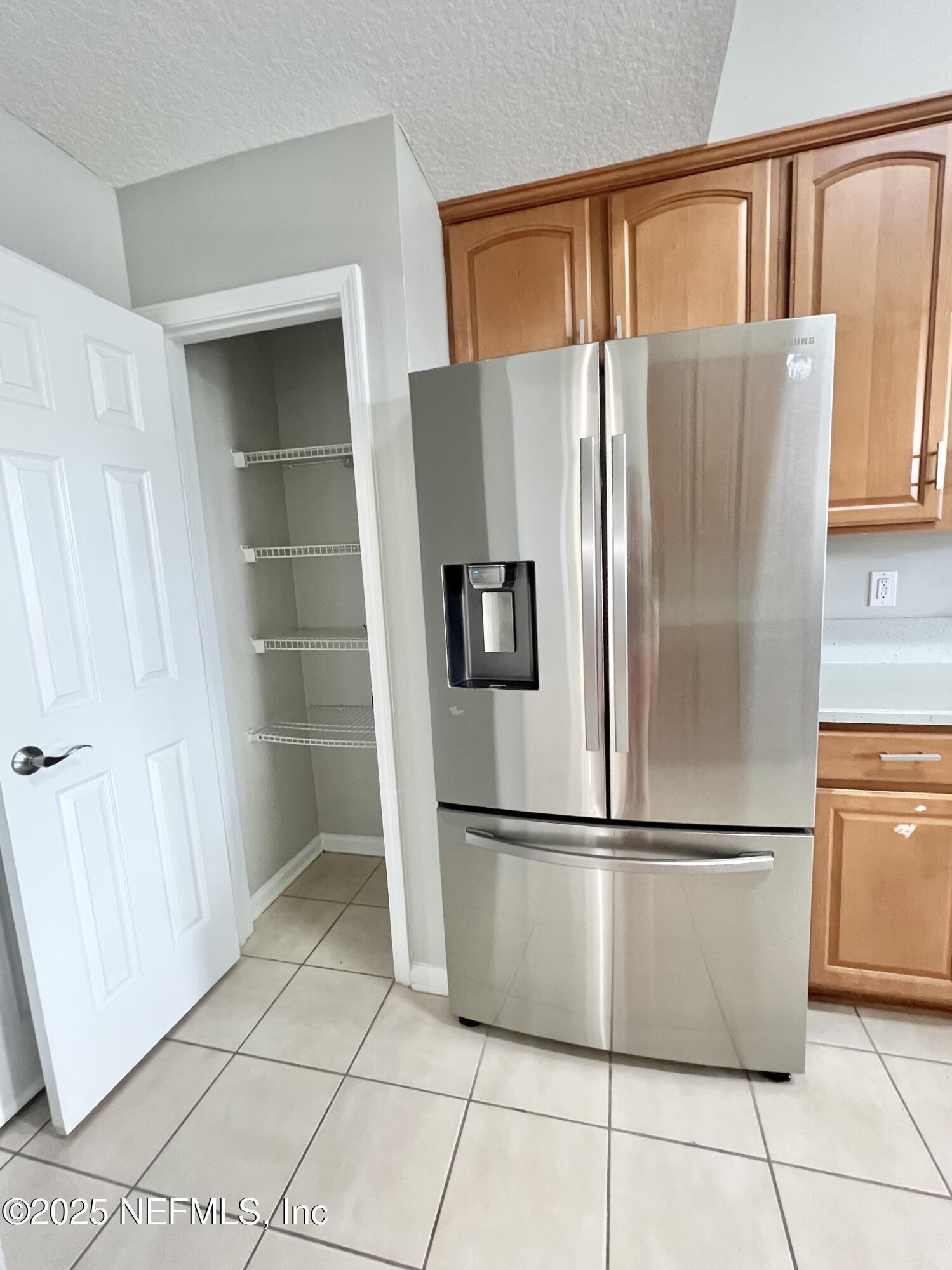 389 Sparrow Branch Circle St. Johns, FL 32259 - Photo 8 of 46 a metallic refrigerator freezer sitting in a kitchen