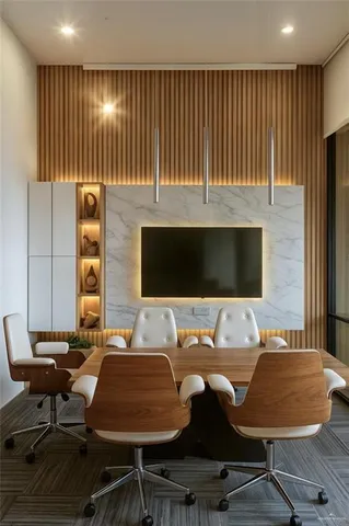 a view of a workspace with furniture and a window