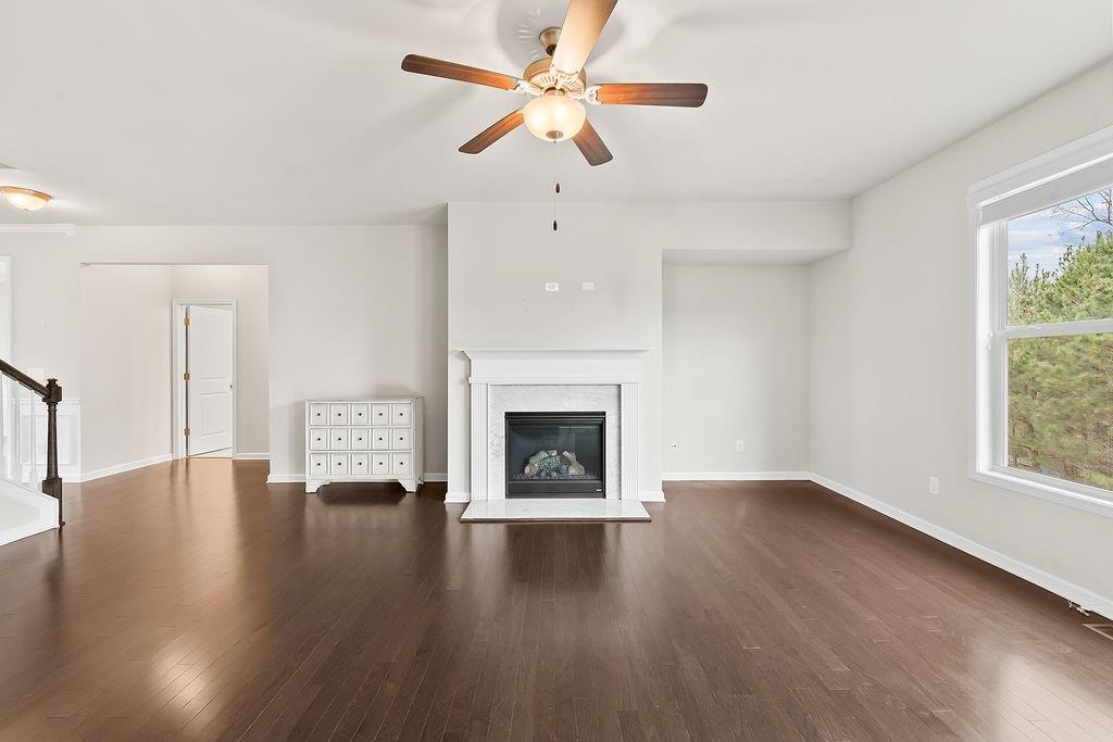 2415 Matlin Way Buford, GA 30519 - Photo 12 of 65 a view of an empty room with a fireplace and a window