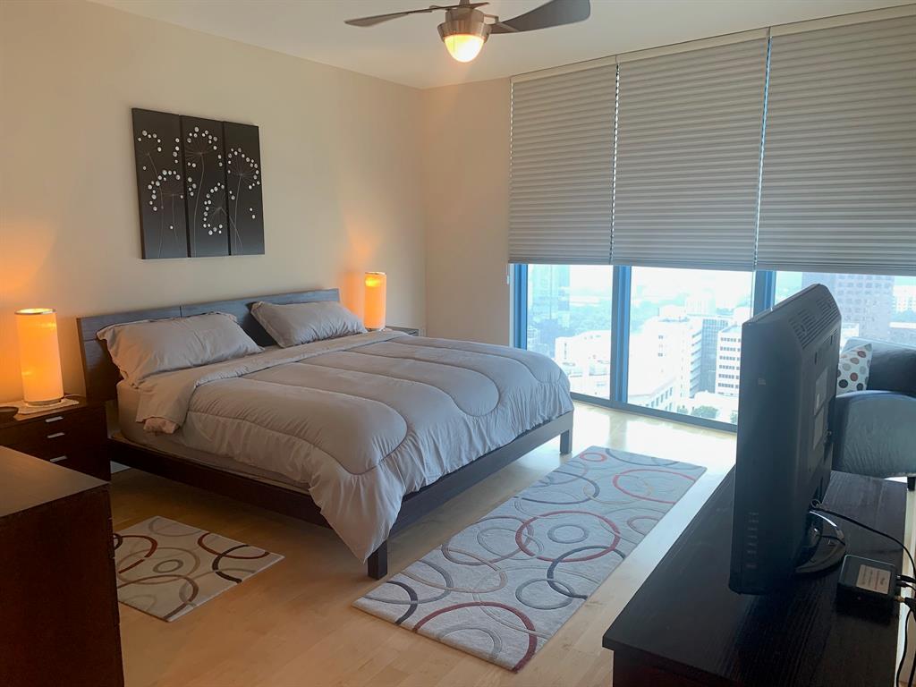 333 Las Olas Way, Unit 2803 Fort Lauderdale, FL 33301 - Photo 16 of 25 a bedroom with a bed and chair with the wooden floor