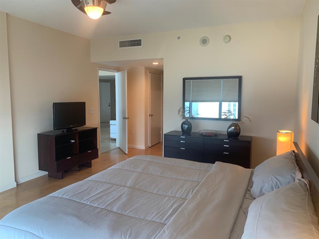 333 Las Olas Way, Unit 2803 Fort Lauderdale, FL 33301 - Photo 18 of 25 a bedroom with a bed and a flat screen tv