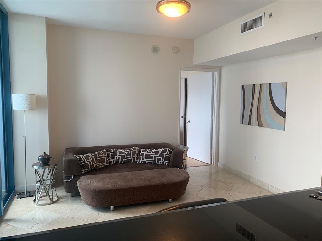 333 Las Olas Way, Unit 2803 Fort Lauderdale, FL 33301 - Photo 21 of 25 a bedroom with a bed and painting on the wall