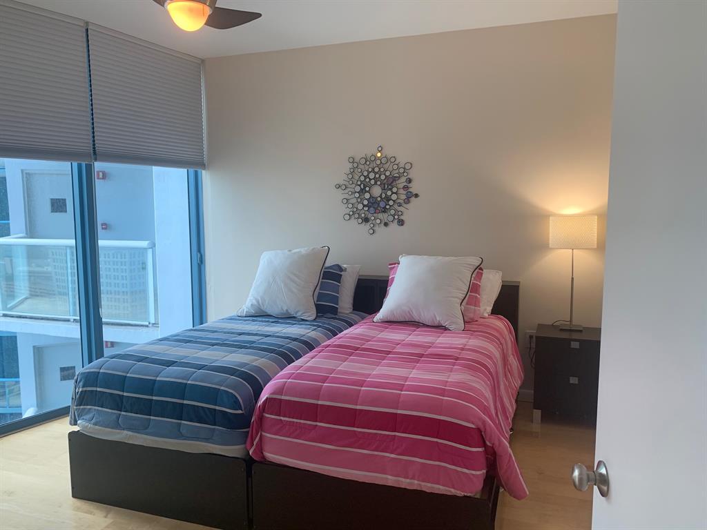 333 Las Olas Way, Unit 2803 Fort Lauderdale, FL 33301 - Photo 22 of 25 a bedroom with two beds and painted walls