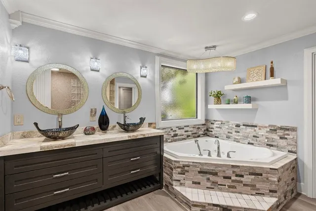 a bathroom with a double vanity sink mirror and shower