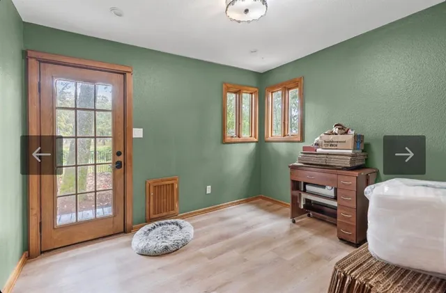 a view of a deck with a big yard and large trees