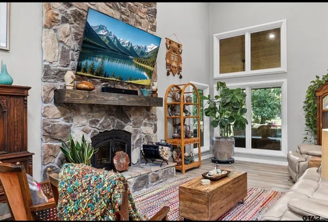 a living room with furniture a fireplace and a night stand