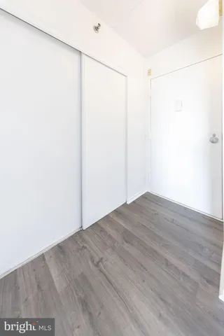a view of a room with wooden floor