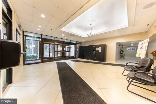 a lobby with a couch and a flat screen tv