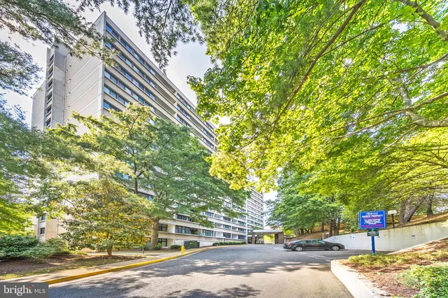 a front view of a house with a yard and tree s