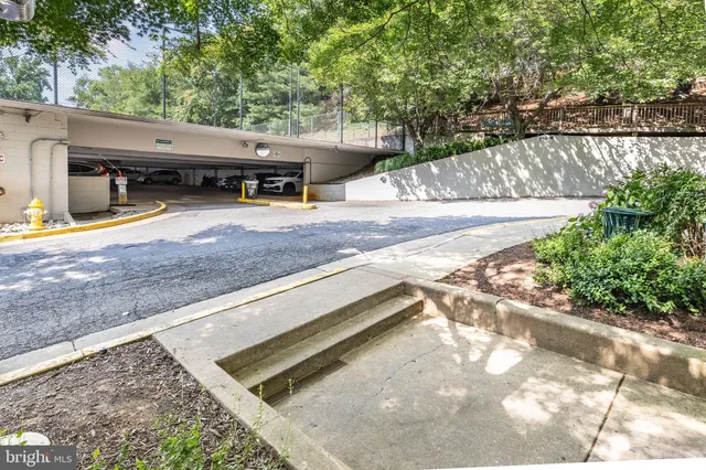 a view of a roof deck with wooden fence and a bench