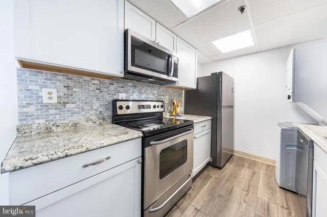 a bathroom with a double vanity sink mirror and toilet