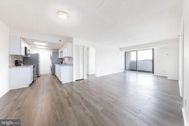 a view of a kitchen with a sink and a stove top oven